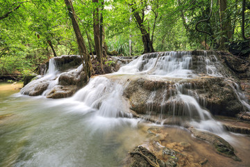 water fall in nature with green trees in Kanchanaburi, Thailand