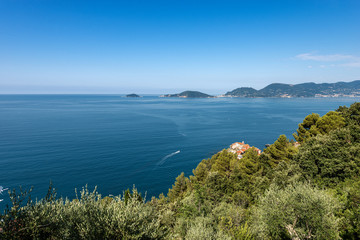 Gulf of La Spezia and Mediterranean sea, with the ancient and small village of Tellaro. In the background the islands of Palmaria, Tino and Tinetto an the Portovenere Town. Liguria, Italy, Europe