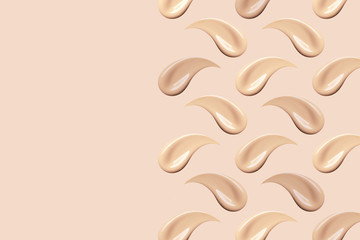 Makeup smears on beige background. Nude foundation smudges isolated. Skin tone BB, CC cream texture. Liquid make up base strokes. Creamy cosmetic beauty product swatch pattern.