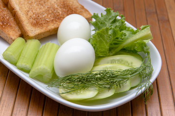 Dietary breakfast, toast, boiled eggs and green vegetables