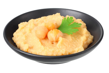 black bowl with chickpea hummus isolated on white background