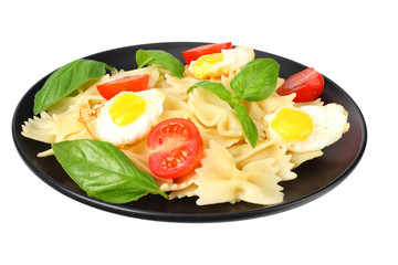 black plate of pasta farfalle isolated on white background