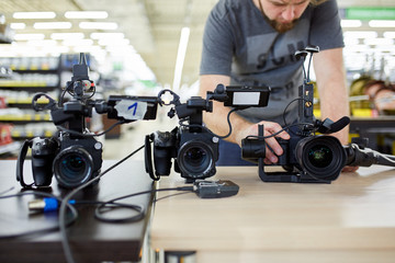 Behind the scenes of movie shooting or video production and film crew team with camera equipment at...