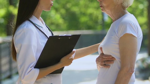 Retired pensioner complaining to doctor of pain in pancreas and heart sanatorium