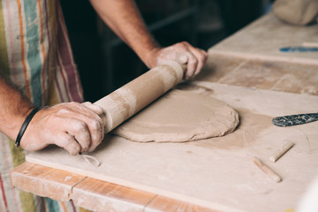 Man creating pottery in his studio