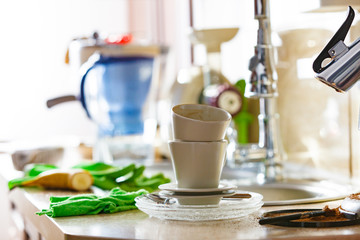 Dirty cups after coffee drinking, messy kitchen
