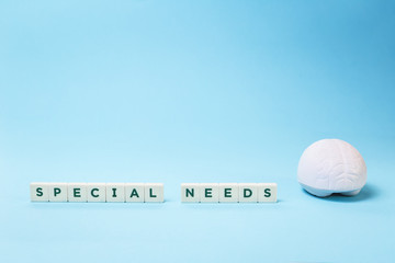 Special needs words with a brain stress relief on blue background, mental emotional physical disability or disorder. Health impared ADHD dyslexia concept. Education and neurology with copy space - obrazy, fototapety, plakaty