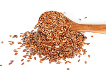 Brown flax seed in spoon on white background.