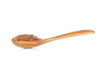 Brown flax seed in spoon on white background.