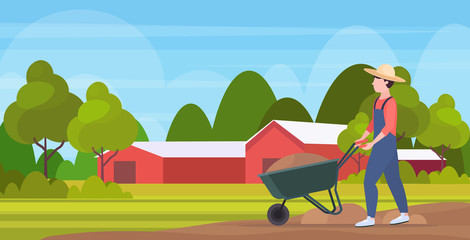 gardener man pushing wheelbarrow loaded with soil farmer working agricultural planting harvesting gardening eco farming concept farmland countryside landscape full length horizontal