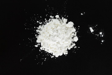white flour cooking on black background.