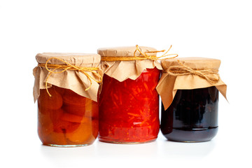 set og  glass bottles with preserved food on white background