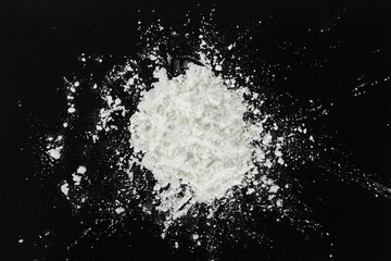 Obraz na płótnie Canvas white flour cooking on black background.