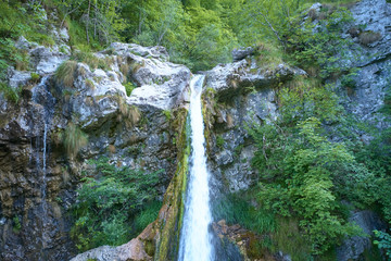 Aerial photography, waterfall in the mountains in the north of the Italian Alps. Trento, Italy.