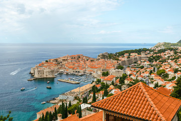 Naklejka na ściany i meble Beautiful townscape of Dubrovnik city in Croatia, panorama view. Old town and blue bay with boats