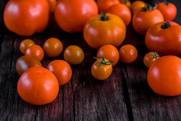 Fototapeta na wymiar tomatoes on a wooden background