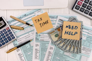 Tax time, 1040 form and clock on table