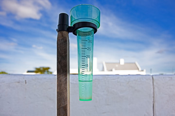 Green rain gauge with water
