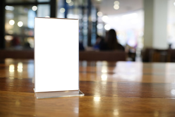 Menu frame space for text marketing promotion standing on wood table in Bar restaurant cafeใ