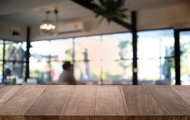 Empty dark wooden table in front of abstract blurred bokeh background of restaurant . can be used for display or montage your products.Mock up for space.