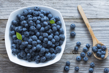Fresh blueberries on wooden background, seasonal healthy fruits