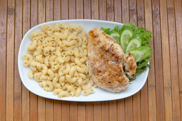 Grilled chicken fillet, pasta and greens