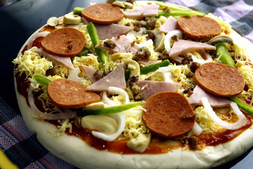 Freshly made vegetable and meat pizza