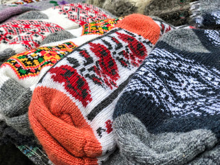pile of knitted woven socks at a market