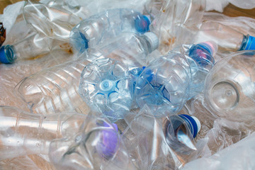 Lot of plastic crumpled empty bottles pollution recycle eco concept background close up selective focus