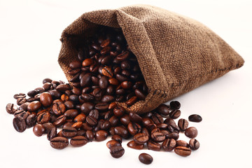 Coffee beans spilling from a jute sack or pouch