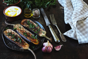 Baked eggplants with garlic and herbs. Rustik style.