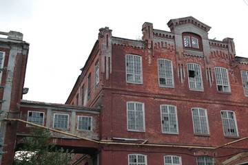 Abandoned red brick old textile fabric in Ivanovo  with background of cloudy sky