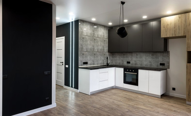New modern empty kitchen interior in white and gray colors, copy space. Kitchen appliances
