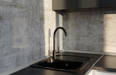 Modern kitchen interior with black ceramic sink and faucet, copy space