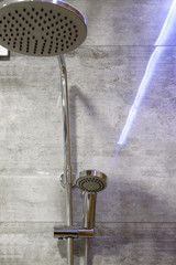 Modern shower on gray tile background in shower cubicle, copy space, close up