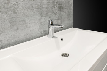 Bathroom interior with white sink and faucet, copy space. Contemporary minimalist washbasin