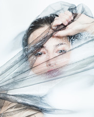 sensual woman creative portrait with black tulle in milk bath