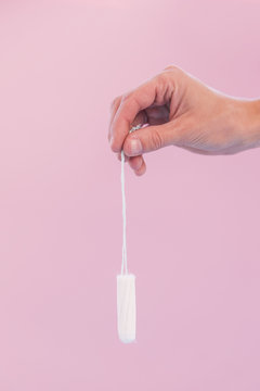 Hand Holding Hanging Tampon