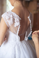 The bride wears a dress,