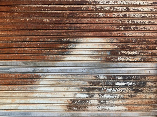 Rusty iron roller shutter, grunge steel iron background