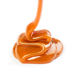 Pouring sweet caramel sauce on white background - obrazy, fototapety, plakaty