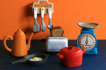 Cookware figures lined up in a colorful kitchen