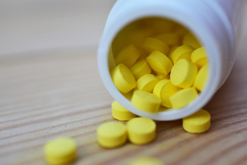 Yellow pills placed on the table