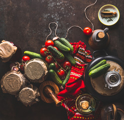 Fototapeta na wymiar Pickle vegetables preparation on dark rustic background with ingredients, vinegar bottle , seasoning and jars. Top view. Copy space. Healthy way of harvest storage