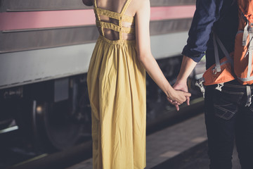 Happy young couple on railway station platform