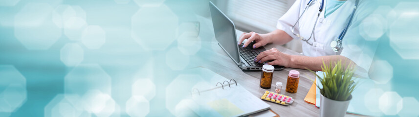 Female doctor using laptop; panoramic banner