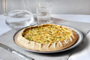 Tart with eggs and green onions on a plate