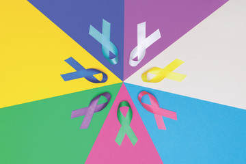 World cancer day background. Colorful ribbons, cancer awareness. blue surface from above. CMYK...