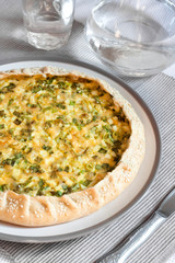 Tart with eggs and green onions on a plate