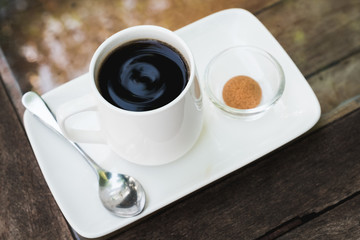 top view black coffee in the white cup on wooden table.